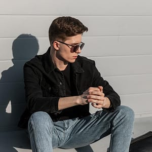 handsome young stylish man vintage black sunglasses fashionable jeans clothes